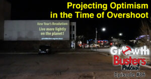 Projection on building: New Year's Resolution - Live more lightly on the planet. Projecting optimism in the time of overshoot