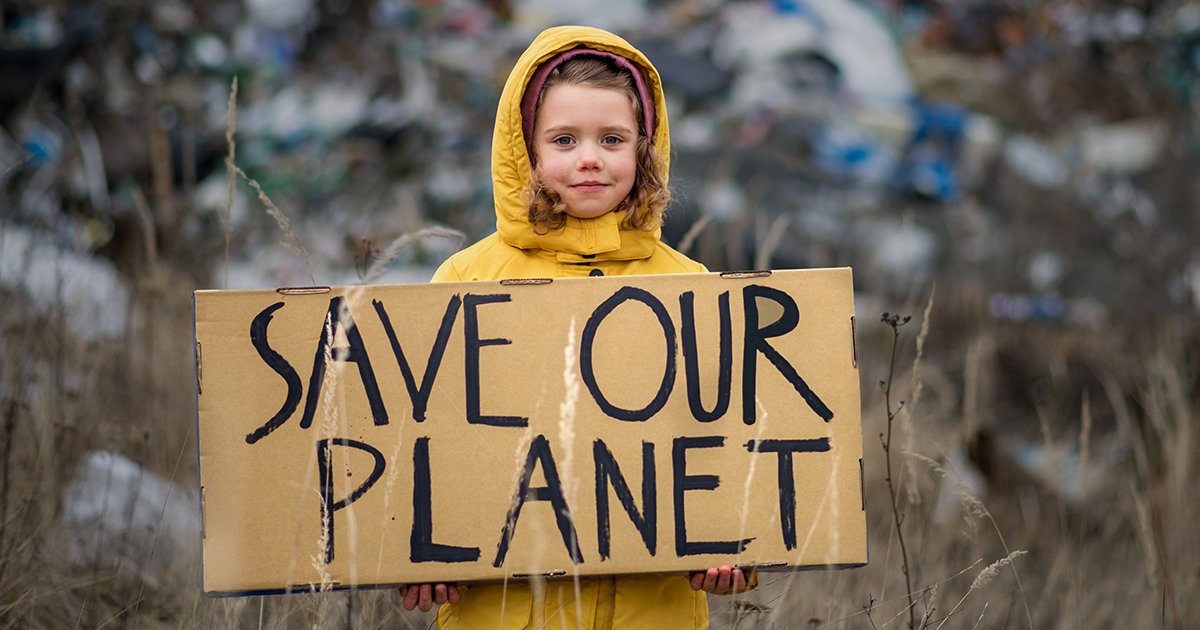 child holding sign: Save Our Planet